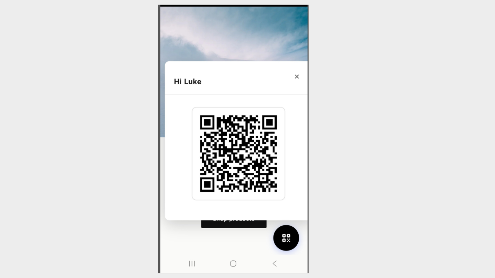 Storefront on a phone showing the floating VahaPOS QR button and a popup greeting the customer by name with their QR code